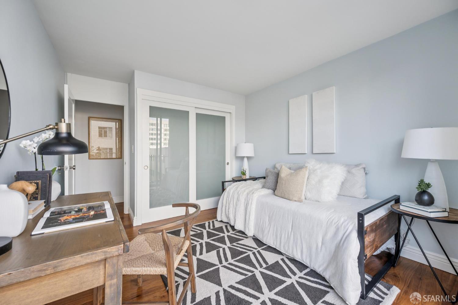 66 Cleary Court, Unit 508 San Francisco, CA 94109 - Photo 17 of 23 a bedroom with a bed and a lamp on table