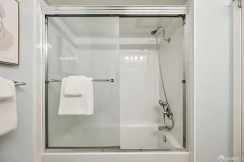 a bathroom with a glass shower door and a sink