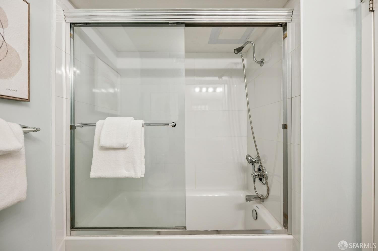 66 Cleary Court, Unit 508 San Francisco, CA 94109 - Photo 19 of 23 a bathroom with a glass shower door and a sink