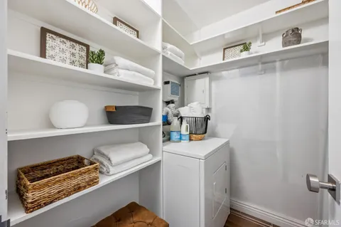 a utility room with sink dryer and washer
