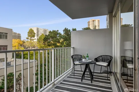 a view of a balcony with furniture