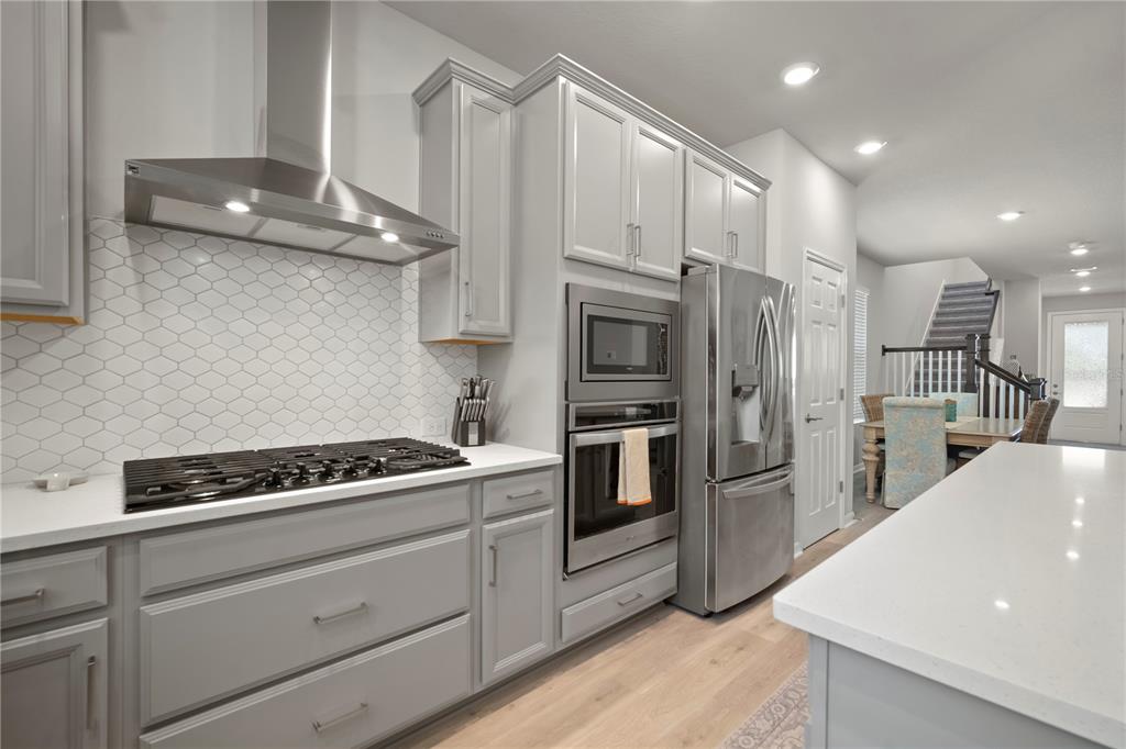 5636 Silver Sun Drive Apollo Beach, FL 33572 - Photo 24 of 61 a kitchen with cabinets and steel stainless steel appliances