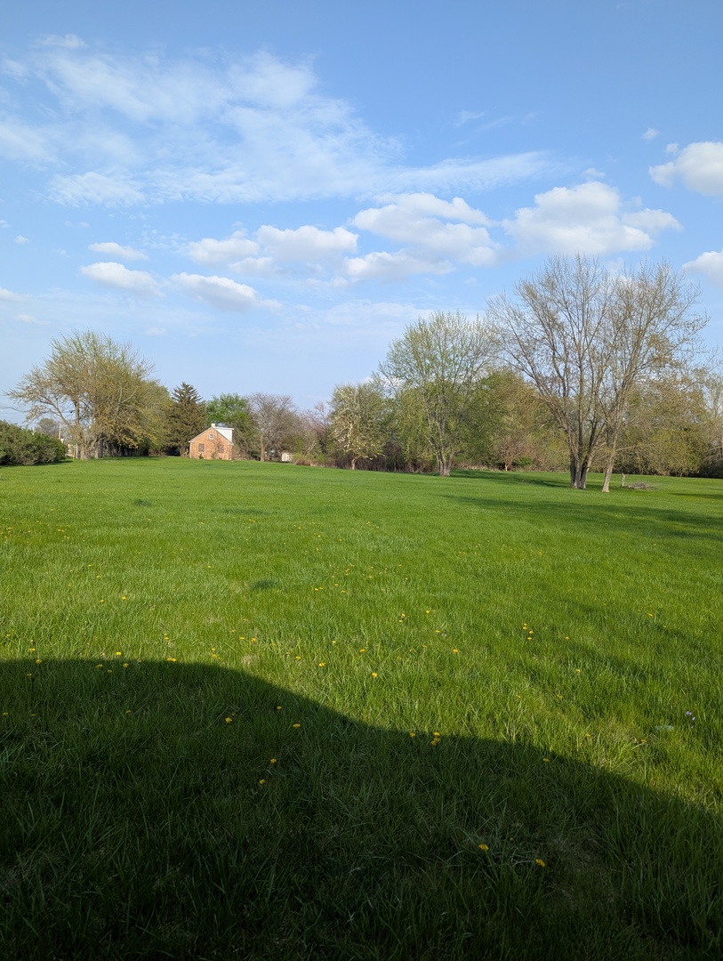 582 West Dresser Road DeKalb, IL 60115 - Photo 5 of 10 a view of a big yard with grass and a city view