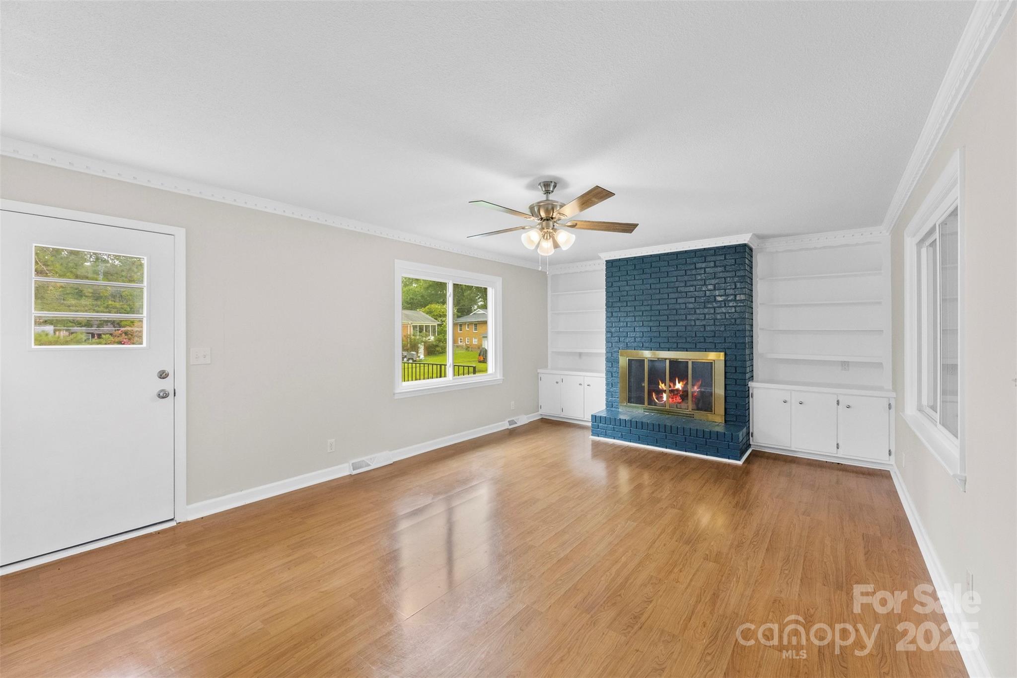 404 Kings Street Cherryville, NC 28021 - Photo 12 of 33 a view of an empty room with a window and wooden floor