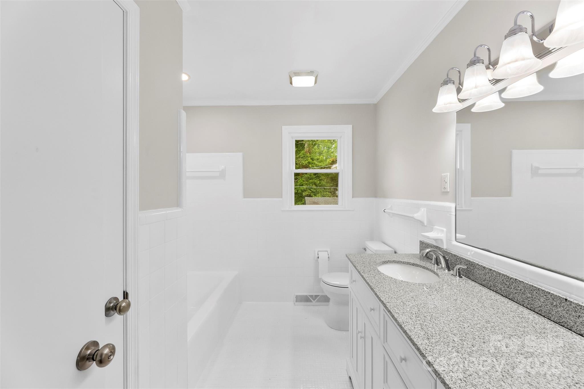 404 Kings Street Cherryville, NC 28021 - Photo 17 of 33 a bathroom with a granite countertop sink a toilet and a mirror