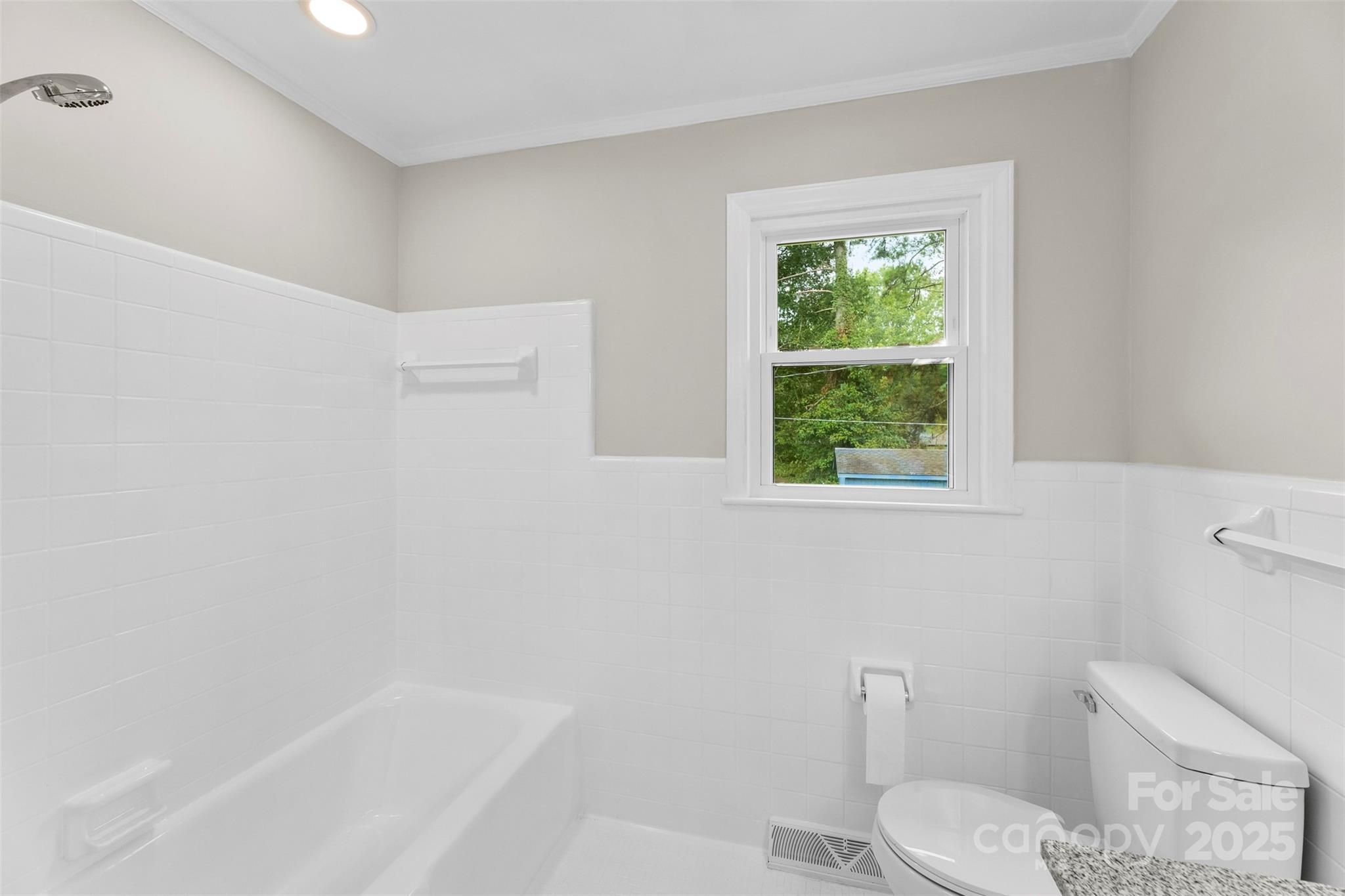 404 Kings Street Cherryville, NC 28021 - Photo 18 of 33 a white toilet sitting next to a bath tub