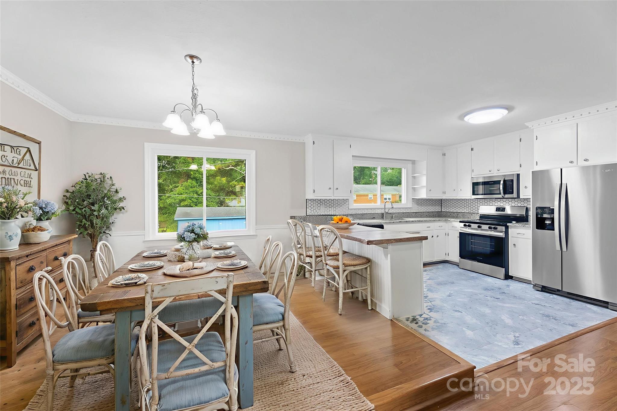 404 Kings Street Cherryville, NC 28021 - Photo 7 of 33 a kitchen with stainless steel appliances kitchen island granite countertop a table chairs stove and refrigerator