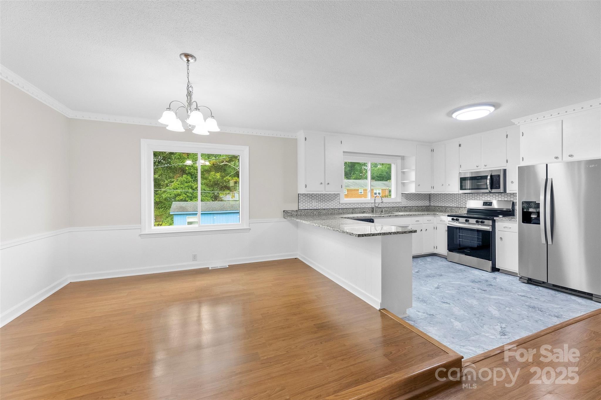 404 Kings Street Cherryville, NC 28021 - Photo 8 of 33 a kitchen with stainless steel appliances granite countertop a sink stove and refrigerator