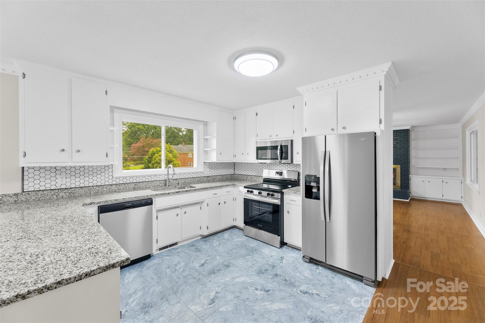 404 Kings Street Cherryville, NC 28021 - Photo 10 of 33 a kitchen with stainless steel appliances granite countertop a sink stove and refrigerator