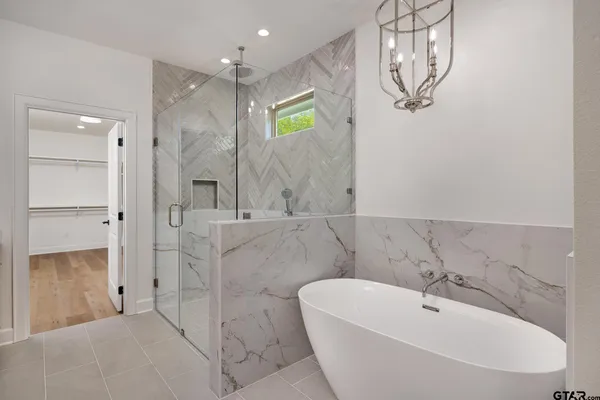 a bathroom with a bathtub and shower