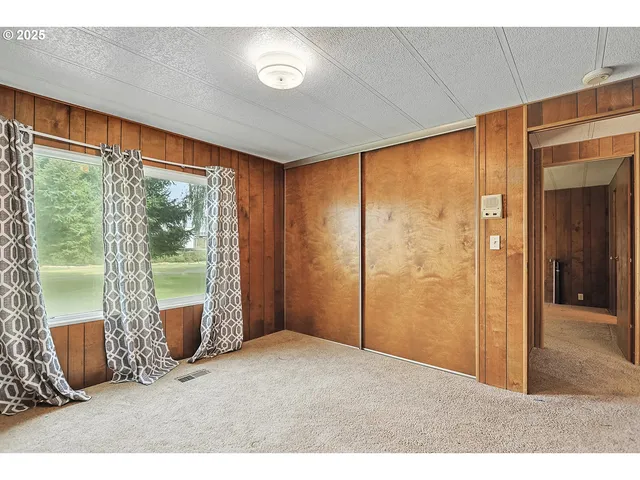 a view of an empty room with windows