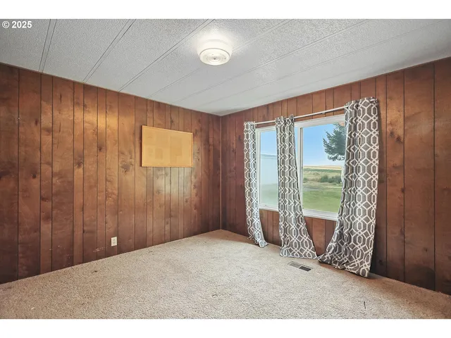 a view of an empty room with floor to ceiling window