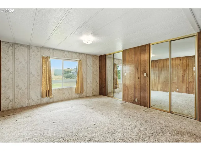 a view of an empty room with glass door