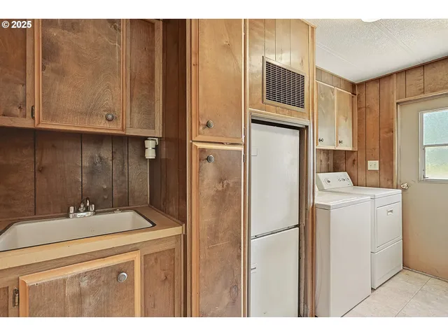 a bathroom with a sink and a refrigerator