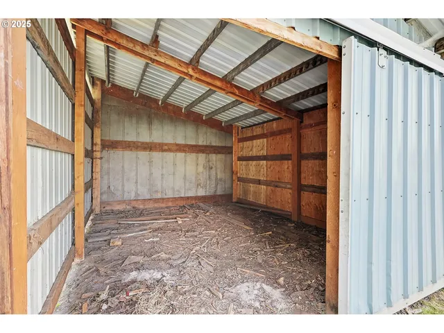 a view of backyard of house with yard and garage