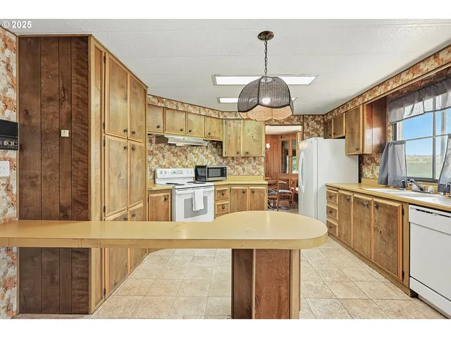 a kitchen with stainless steel appliances kitchen island granite countertop a sink and cabinets