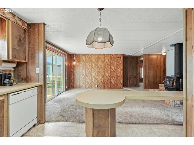 a view of a room with a kitchen and windows