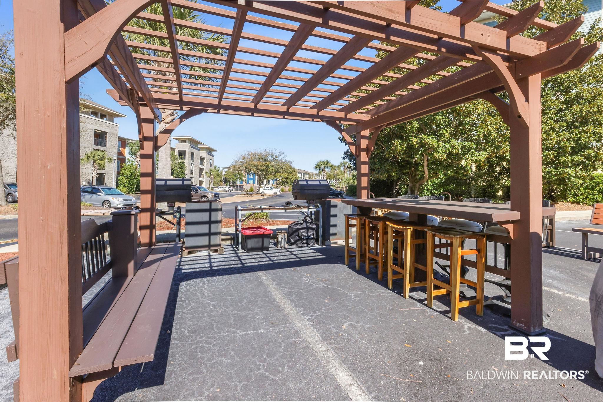 1430 Regency Road, Unit B302 Gulf Shores, AL 36542 - Photo 23 of 24 View of patio featuring outdoor dry bar and a pergola