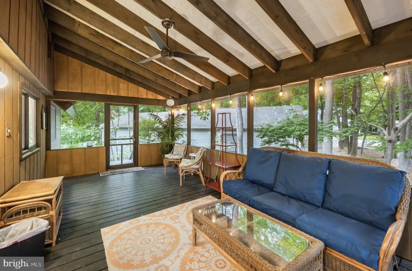 5 Falcon Bridge Road Ocean Pines, MD 21811 - Photo 7 of 59 a living room with furniture a wooden floor and a large window
