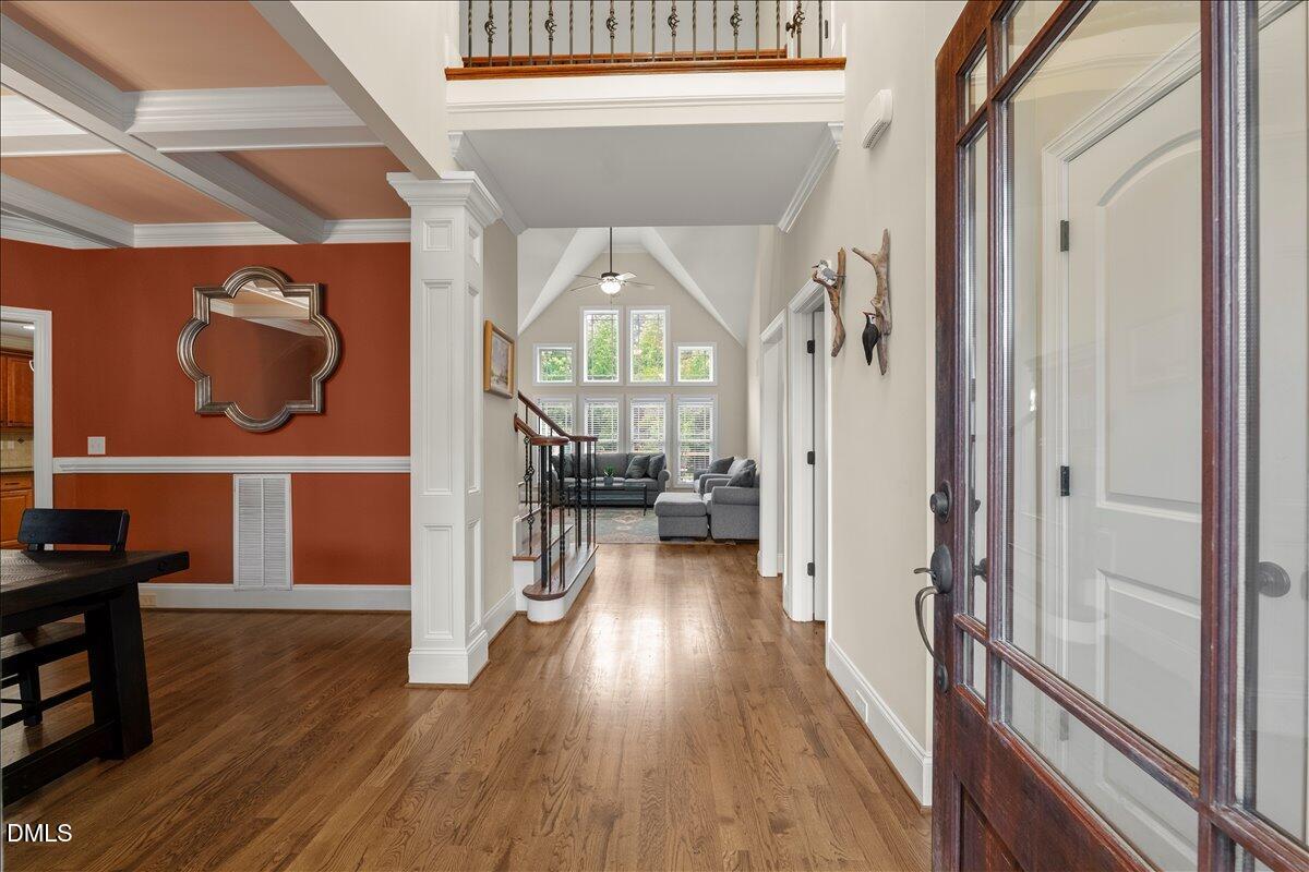 7400 Denlee Road Raleigh, NC 27603 - Photo 5 of 47 a view of a hallway with wooden floor windows and a living room