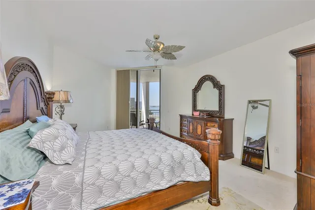 a bedroom with a large bed and a chandelier