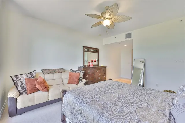 a bedroom with a large bed and a chandelier