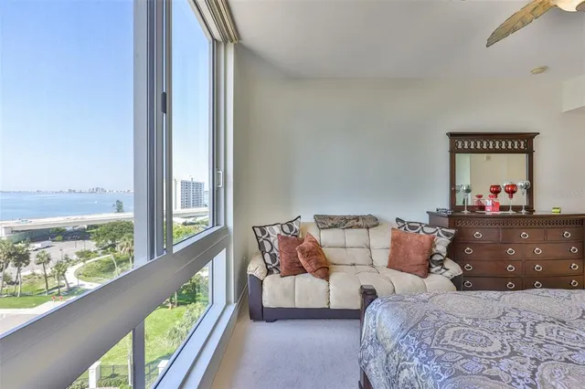 a bedroom with furniture and a large window