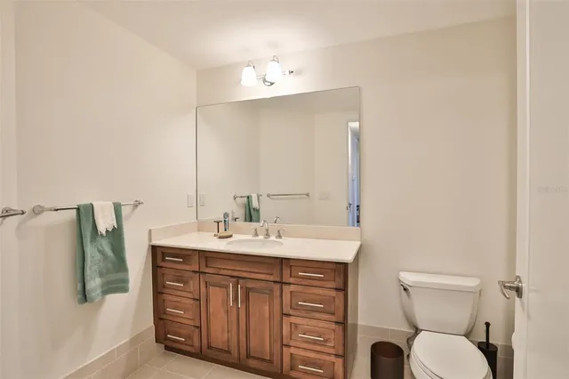 a bathroom with a toilet a sink and mirror