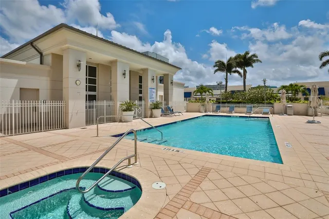 a swimming pool with outdoor seating and yard