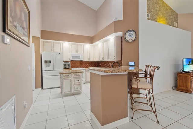 a kitchen with cabinets appliances and a counter space
