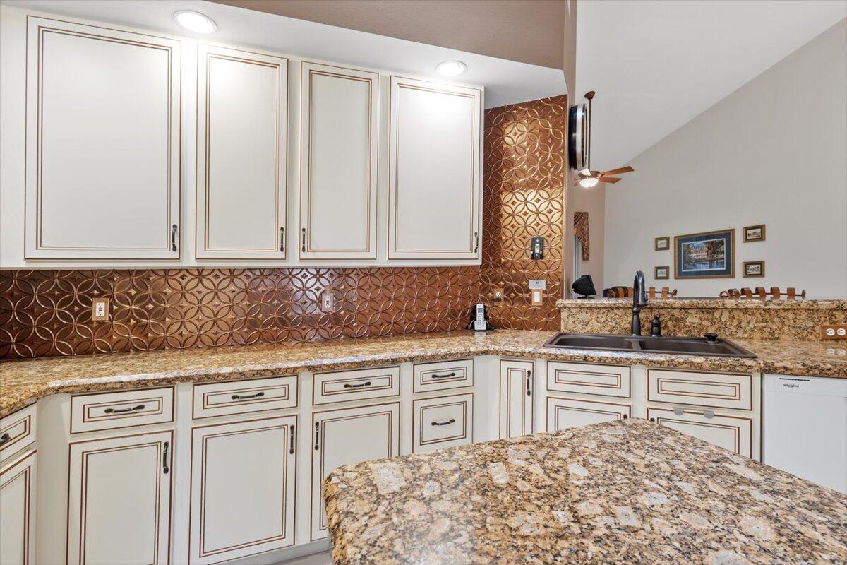 1634 Southwest Harbour Isles Circle, Unit 89 Port St. Lucie, FL 34986 - Photo 16 of 71 a kitchen with stainless steel appliances granite countertop a sink and cabinets