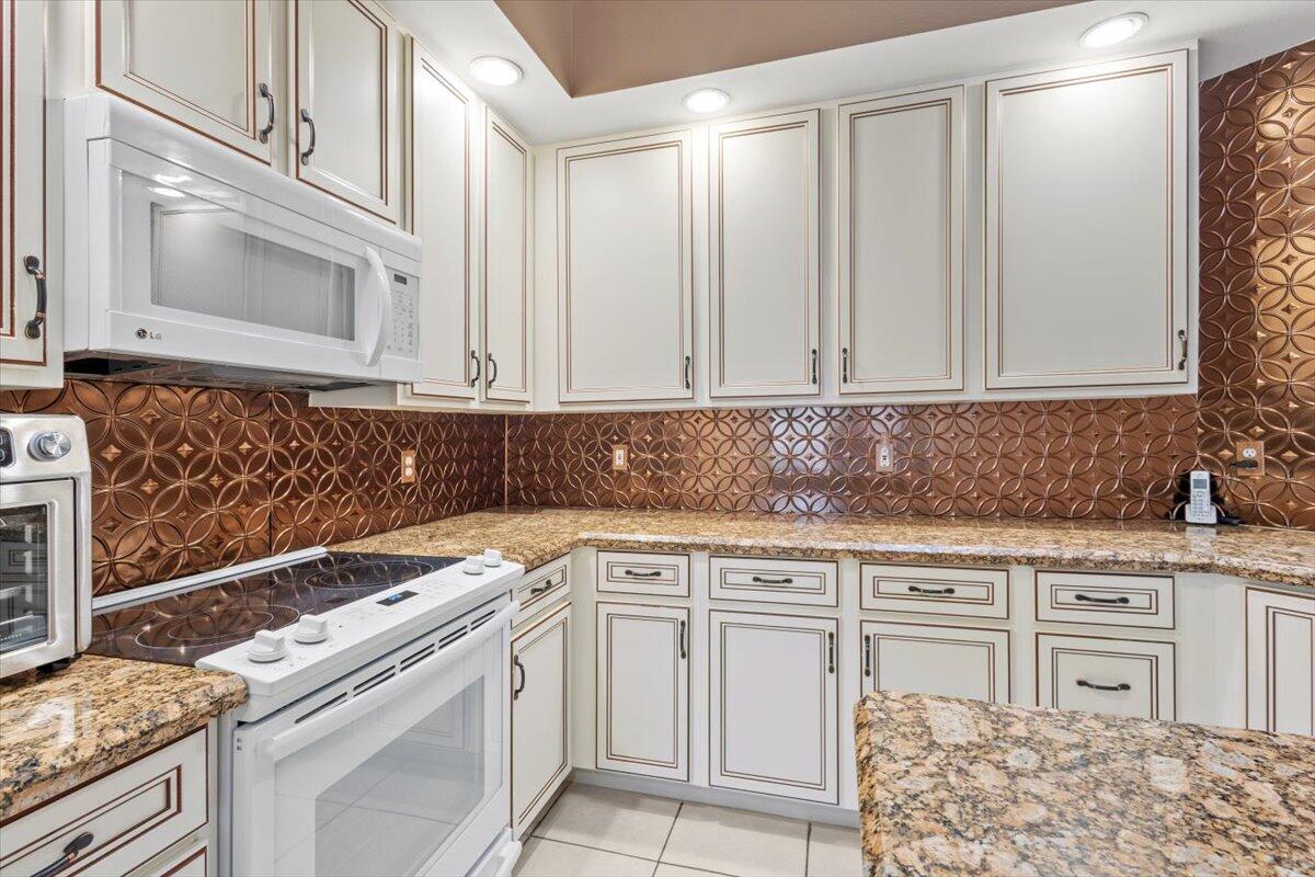 1634 Southwest Harbour Isles Circle, Unit 89 Port St. Lucie, FL 34986 - Photo 17 of 71 a kitchen with granite countertop cabinets stainless steel appliances and a counter space