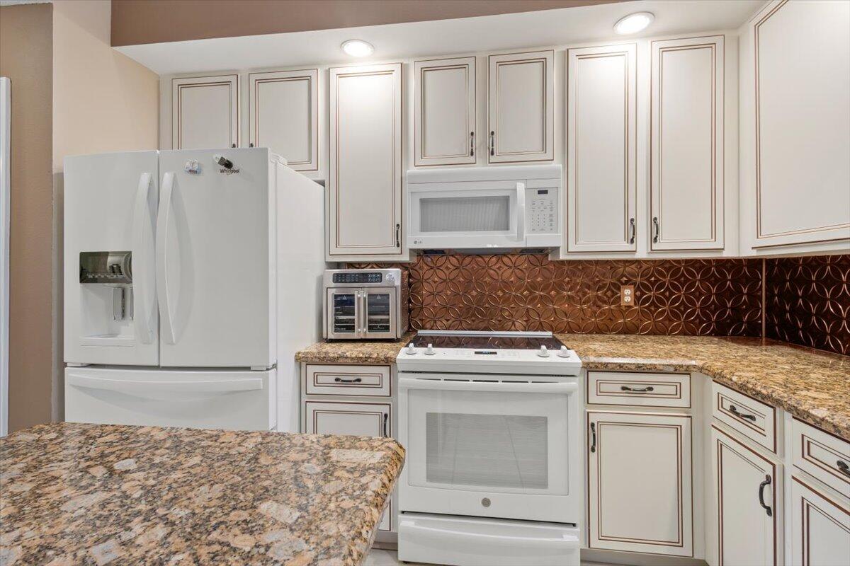 1634 Southwest Harbour Isles Circle, Unit 89 Port St. Lucie, FL 34986 - Photo 18 of 71 a kitchen with cabinets appliances and a counter space