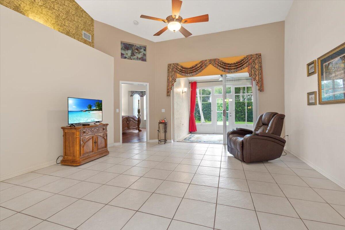 1634 Southwest Harbour Isles Circle, Unit 89 Port St. Lucie, FL 34986 - Photo 24 of 71 a living room with furniture and a flat screen tv