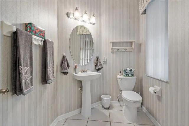 a view of a room with window and carpet