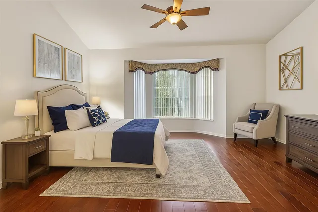 a view of a livingroom with wooden floor and a bathroom