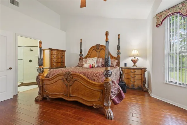 a large bedroom with a bed and a chandelier