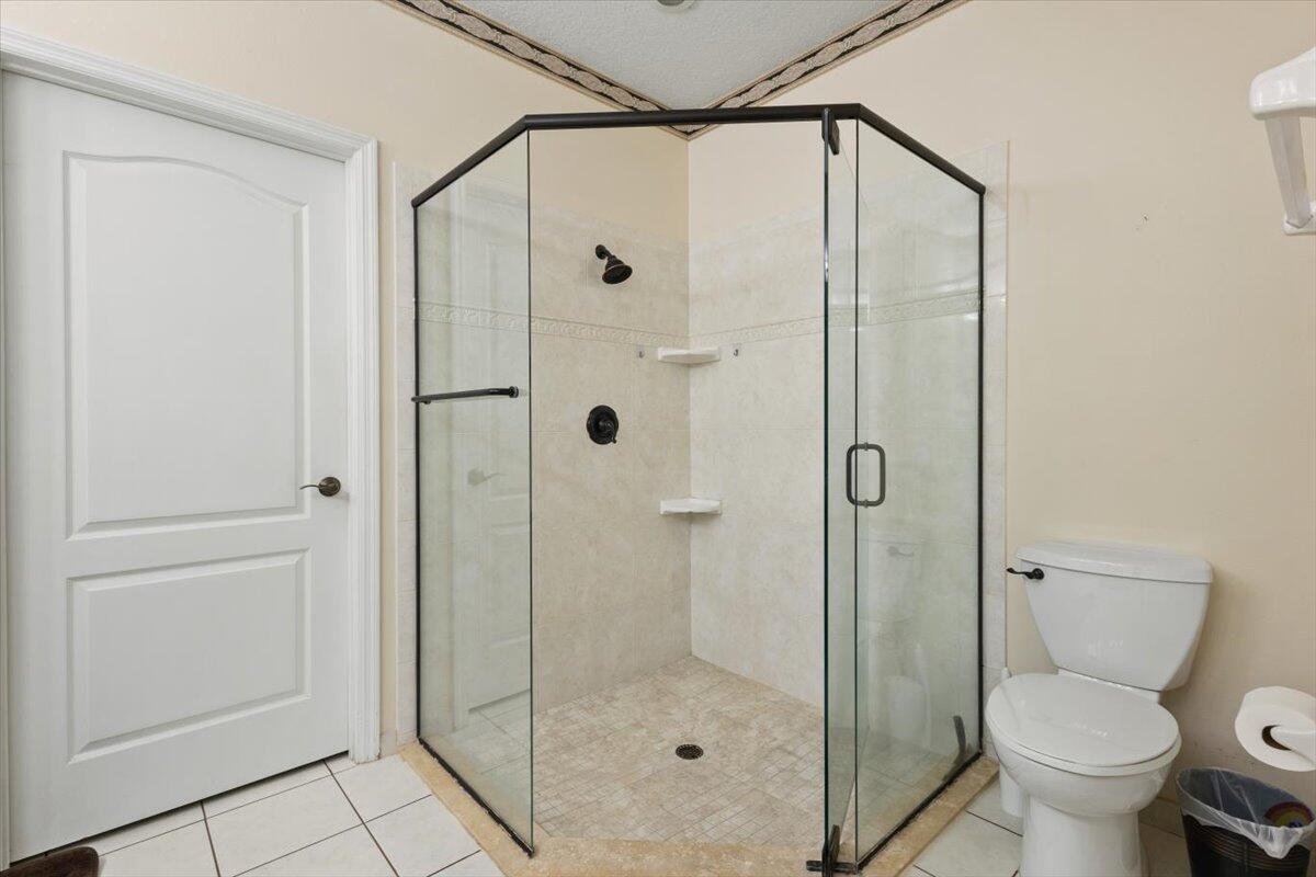 1634 Southwest Harbour Isles Circle, Unit 89 Port St. Lucie, FL 34986 - Photo 34 of 71 a bathroom with a shower and a toilet
