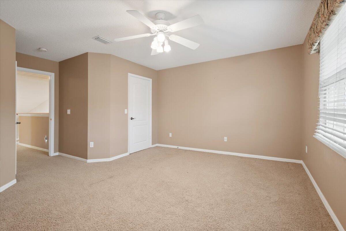 1634 Southwest Harbour Isles Circle, Unit 89 Port St. Lucie, FL 34986 - Photo 45 of 71 an empty room with windows and ceiling fan