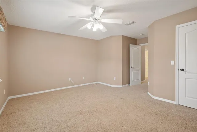 a view of a dining room with furniture and a bookshelf