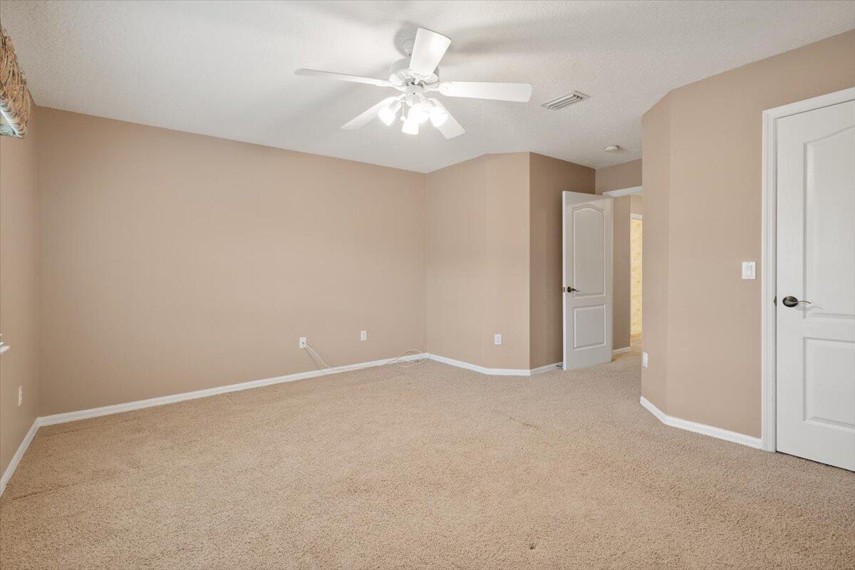 1634 Southwest Harbour Isles Circle, Unit 89 Port St. Lucie, FL 34986 - Photo 46 of 71 an empty room with a ceiling fan and a window