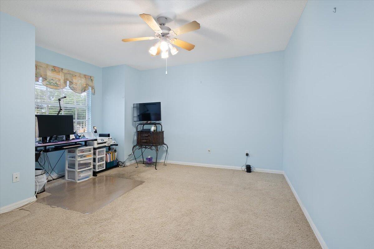 1634 Southwest Harbour Isles Circle, Unit 89 Port St. Lucie, FL 34986 - Photo 49 of 71 an empty room with furniture and flat screen tv