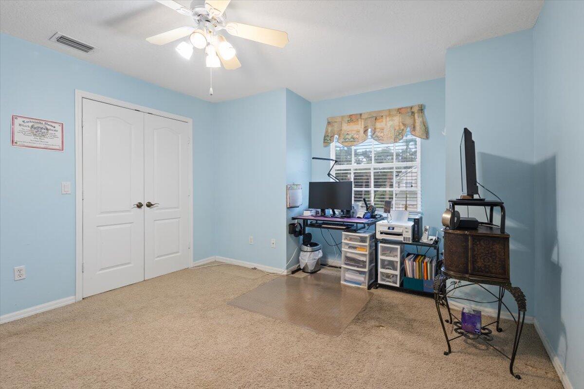 1634 Southwest Harbour Isles Circle, Unit 89 Port St. Lucie, FL 34986 - Photo 50 of 71 a view of a workspace with furniture and a window