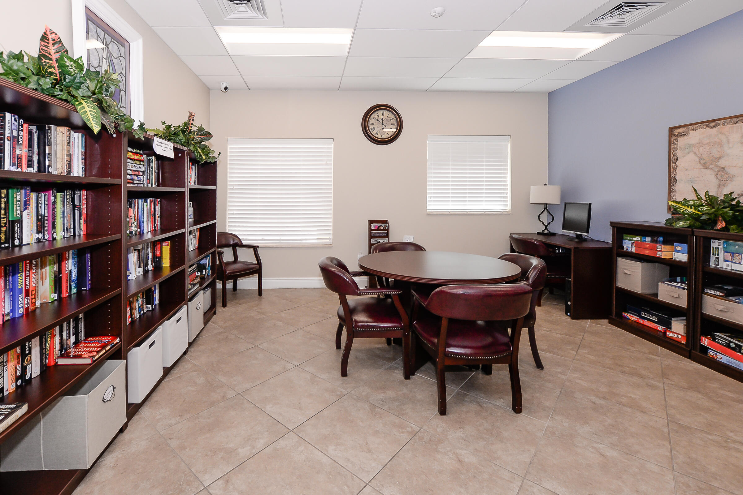 1634 Southwest Harbour Isles Circle, Unit 89 Port St. Lucie, FL 34986 - Photo 66 of 71 a view of a dining room with furniture and a bookshelf
