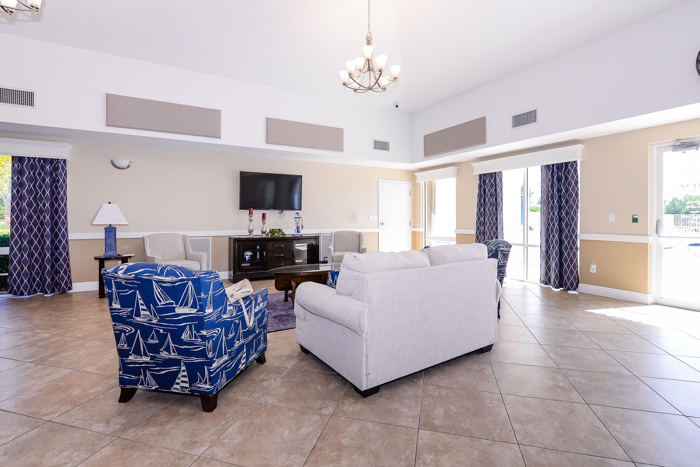 1634 Southwest Harbour Isles Circle, Unit 89 Port St. Lucie, FL 34986 - Photo 68 of 71 a living room with furniture and a flat screen tv