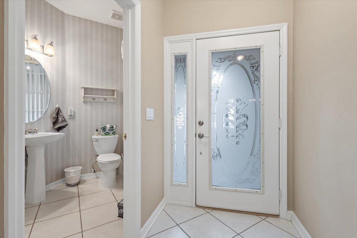 1634 Southwest Harbour Isles Circle, Unit 89 Port St. Lucie, FL 34986 - Photo 8 of 71 a bathroom with a granite countertop toilet and a shower