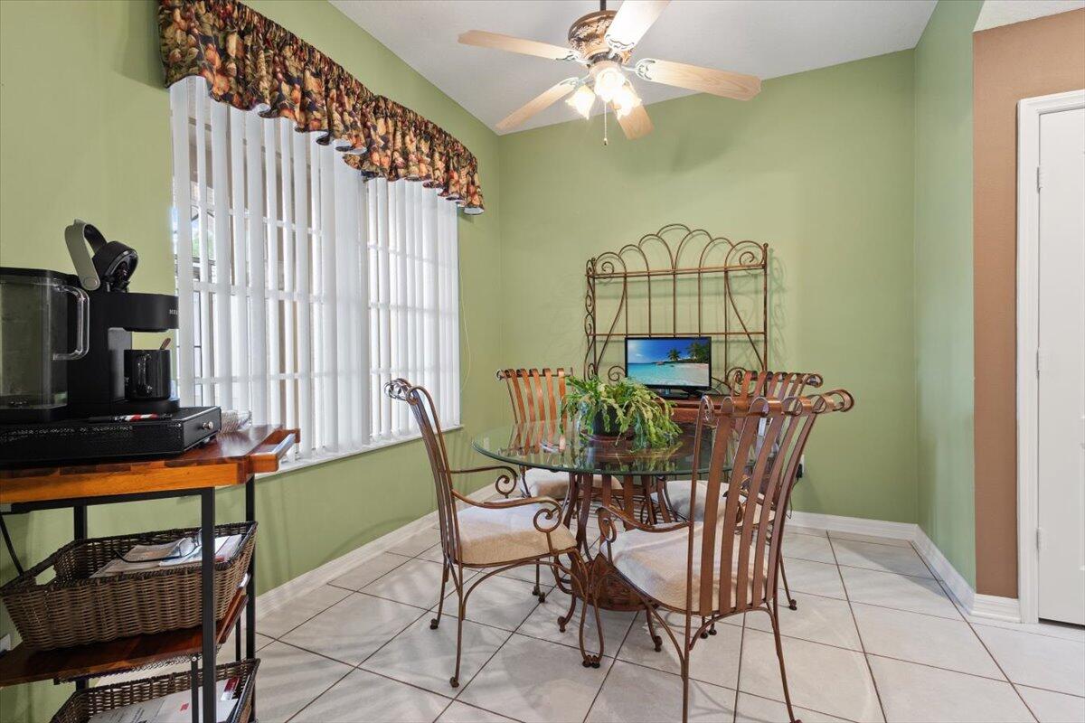 1634 Southwest Harbour Isles Circle, Unit 89 Port St. Lucie, FL 34986 - Photo 9 of 71 a view of a dining room with furniture and a window