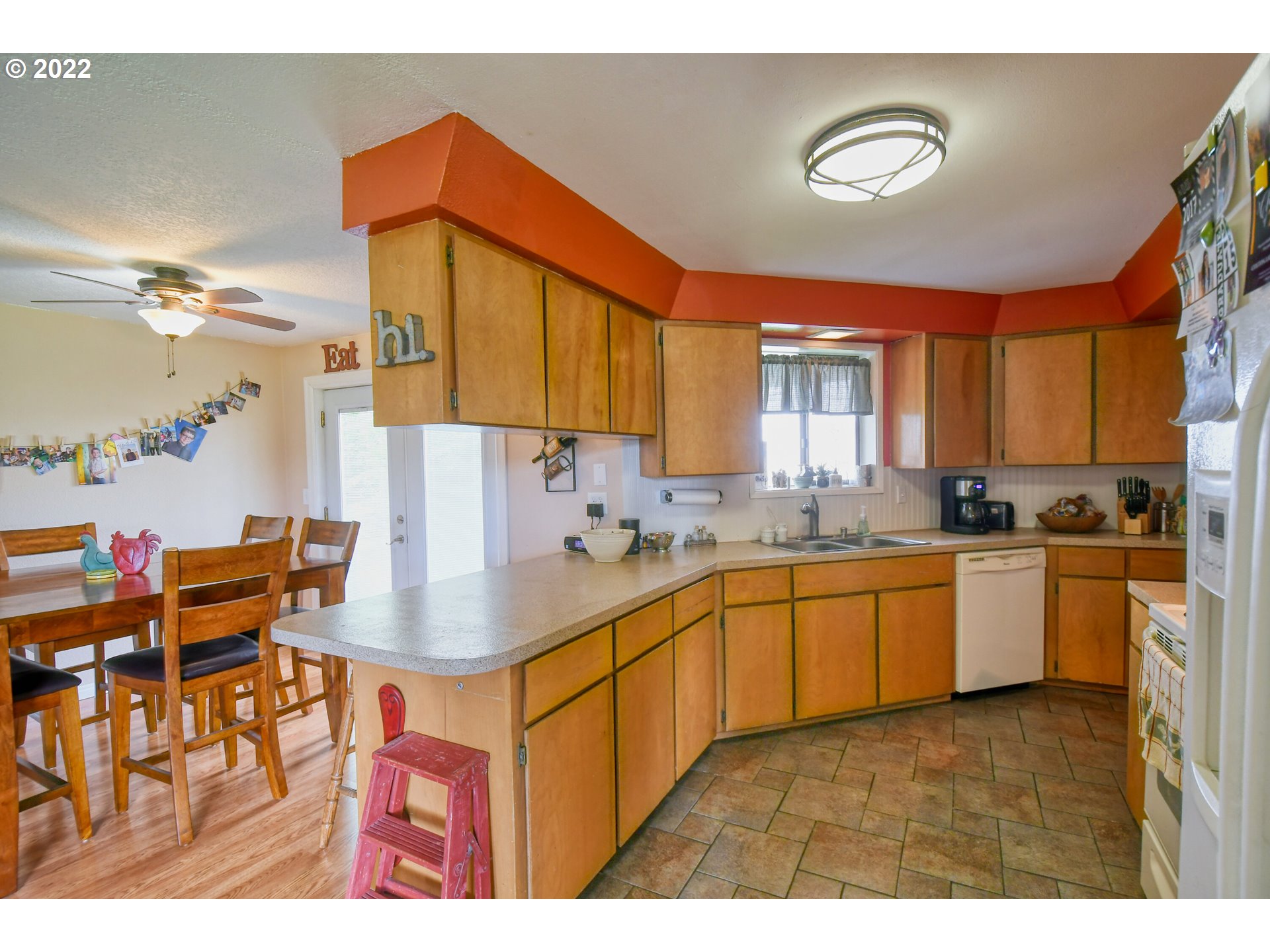 817 Southwest 10th Street Pendleton, OR 97801 - Photo 10 of 25 a kitchen with stainless steel appliances granite countertop a sink dishwasher and a dining table with cabinets