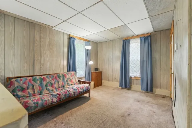 a view of a room with wooden floor and windows
