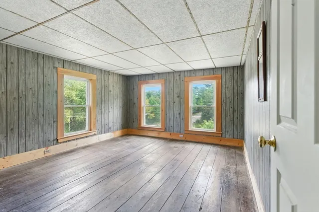 a view of room with wooden floor and large window